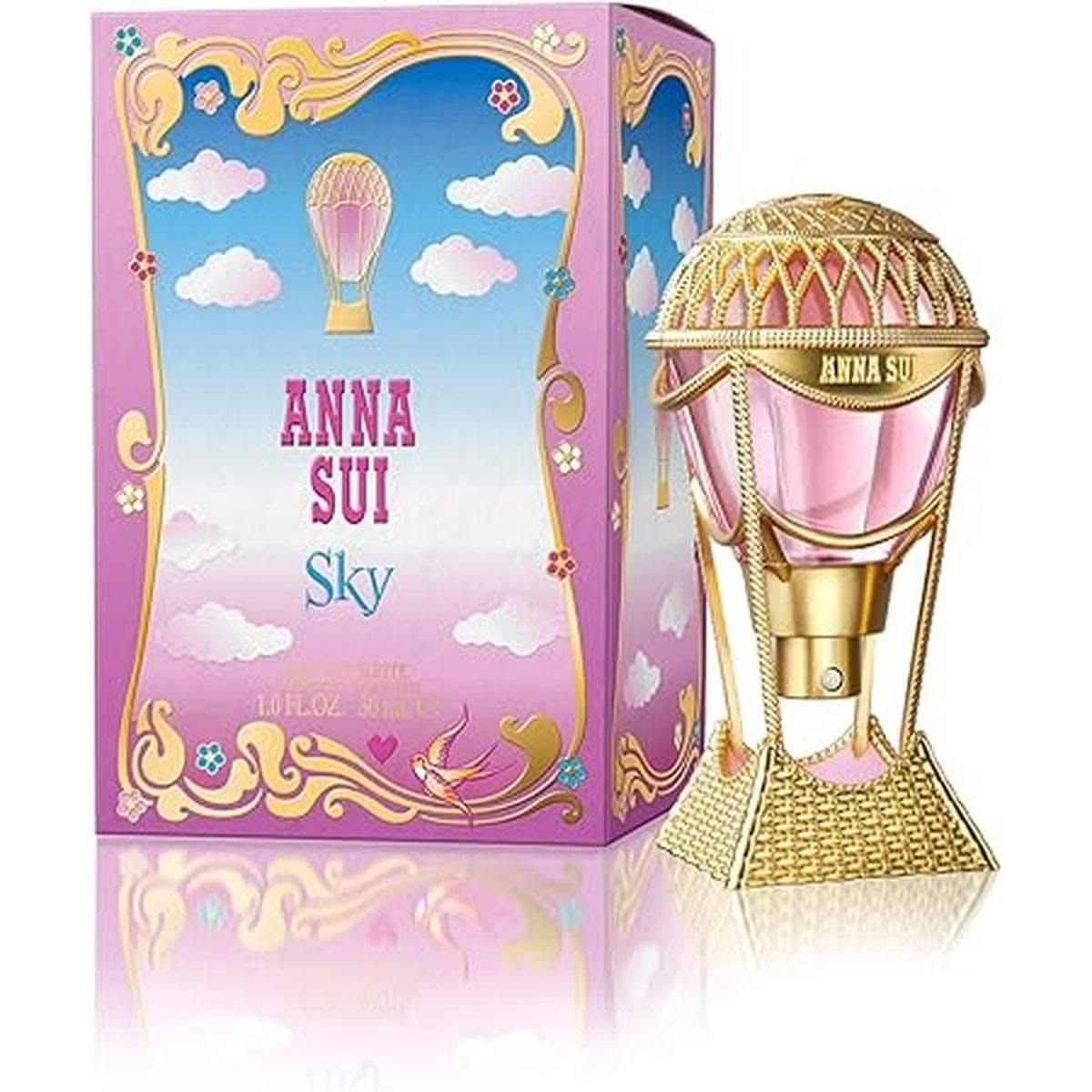 Eau de toilette Anna Sui Sky 30 ml avec un flacon en forme de montgolfière dorée et rose, accompagné de son emballage coloré inspiré du ciel.